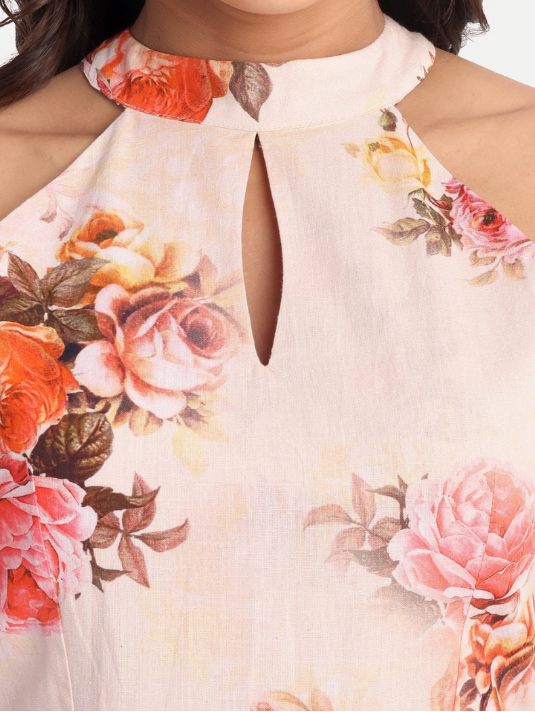 Women’s peach floral Lili mini dress with halter neck and flared silhouette