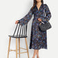 Women’s black and blue floral Reko midi dress with V-neck and elegant flowy fit