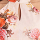 Women’s peach floral Lili mini dress with halter neck and flared silhouette