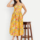 Women’s yellow floral Meto midi dress with strappy sleeves and flowy summer silhouette